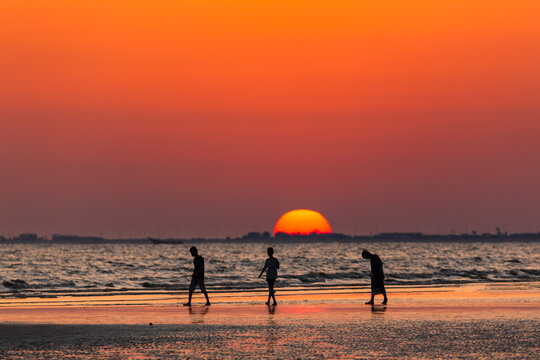 Silhouette of kids playing at beach with sunset background. Yemen nature. Yemen landscape.