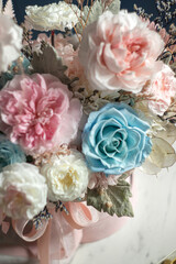 Beautiful flowers. Preserved roses with dried flowers bouquet closeup. Beautiful flower arrangement in a pink box.