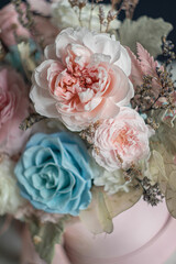 Beautiful flowers. Preserved roses with dried flowers bouquet closeup. Beautiful flower arrangement in a pink box.