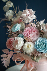 Beautiful flowers. Preserved roses with dried flowers bouquet closeup. Beautiful flower arrangement in a pink box.