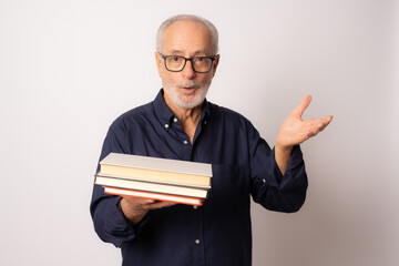 Portrait elderly man holding books over white background.