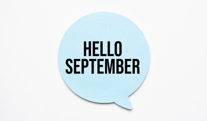 hello september speech bubble and black magnifier isolated on the yellow background.