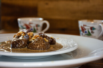 Traditional turkish dessert on plate, fig dessert and in background turkish coffee in cup
