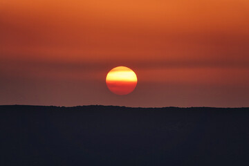 sunset and orange sunrise over the mountains