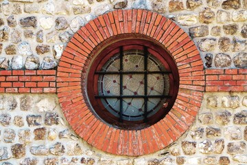Fototapeta na wymiar Round skylight with bricks and bars