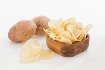 Wooden Bowl With Tasty Potato Chips; Photo On White Background