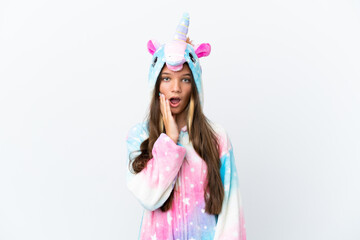 Obraz na płótnie Canvas Little caucasian girl wearing unicorn pajama isolated on white background surprised and shocked while looking right