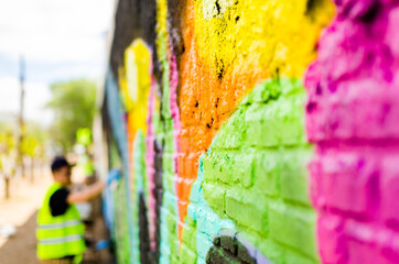 Graffiti with bright colors painted in a wall 