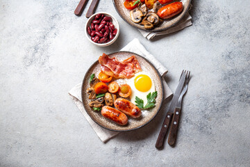 English breakfast with fried eggs, bacon, sausages, beans, toasts on white background