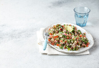Tabbouleh salad is a traditional middle eastern or arab dish. Vegetarian salad with parsley, mint, bulgur, tomato.