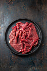 Beef tenderloin with herbs and spices on cast iron plate