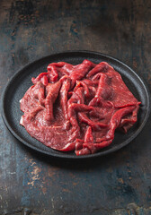 Beef tenderloin with herbs and spices on cast iron plate