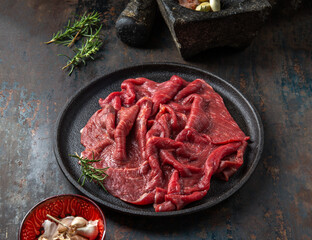 Beef tenderloin with herbs and spices on cast iron plate