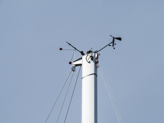 Close up view of the mast head of a sailboat mast showing the wind speed and wind direction...