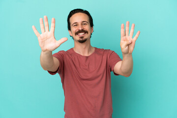 Fototapeta premium Young caucasian man isolated on blue background counting nine with fingers
