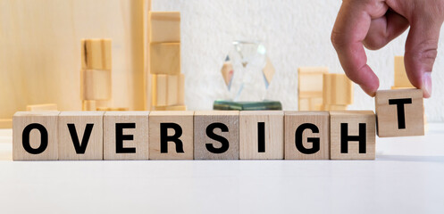 Oversight concept, word Oversight on wooden block