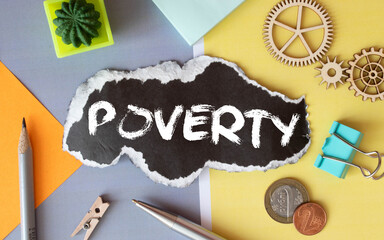 Eraser deleting the word Poverty on black paper