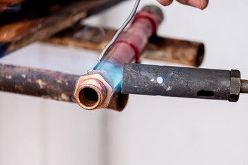 .Repair of water pipe of a house. The welding of the pipes that carry the water is shown