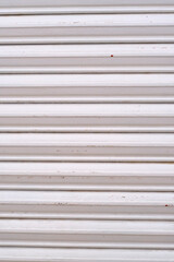 Obraz premium White steel blind froma market local. Vertical photo..Background.