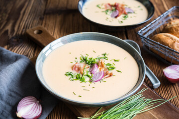 Demikat, classic Slovakian creamy sheep cheese soup topped with roasted bacon and fresh chives