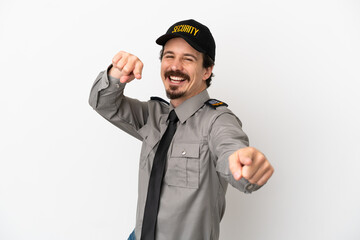 Young caucasian security man isolated on white background points finger at you while smiling