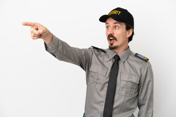 Young caucasian security man isolated on white background pointing away