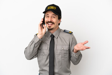 Young caucasian security man isolated on white background keeping a conversation with the mobile phone with someone