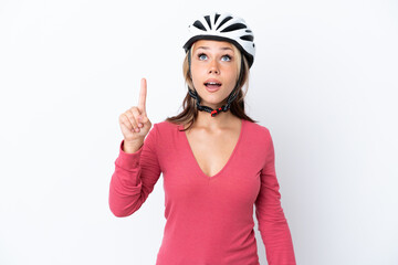 Young Russian woman wearing a bike helmet isolated on white background pointing up and surprised