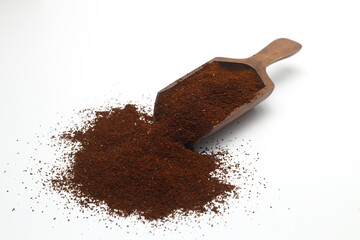 Coffee beans in a wooden scoop isolated on a white background. Roasted coffee beans isolated. A wooden scoop with coffee.