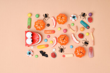 Halloween treats on an orange background. Various candies with a place for text.