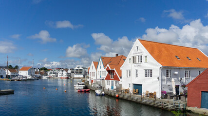 Fototapeta na wymiar Skudeneshavn, Karmøy, Norway. Seafront White houses and wharves.