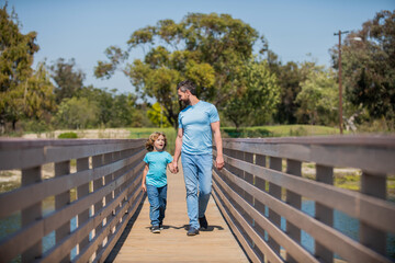 smiling single father leading small kid outside, parenting