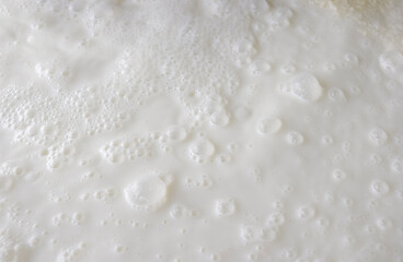 Fototapeta na wymiar Fresh milk. Bubbles forming scene background.