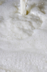 Fototapeta na wymiar Fresh milk. Bubbles forming scene background.