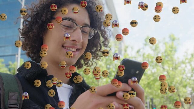 Animation of falling emojis over man using smartphone