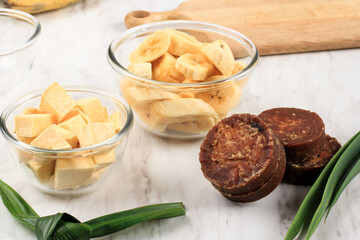 Ingredient Preparation making Banana and Sweet Potato Compote (Kolak Pisang Ubi). Slicing  Banana, Slice Sweet Potato, Palm Sugar (Gula Merah), Pandan Leaves. Popular for Ramadan