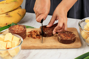 Cooking Process, Slicing Palm Sugar Block, Process Making Kolak, Traditional Indonesian Sweet Soup Made from Banana, Sweet Potato, Coconut Milk Indonesian Traditional Snack Ramadan Breakfasting Menu