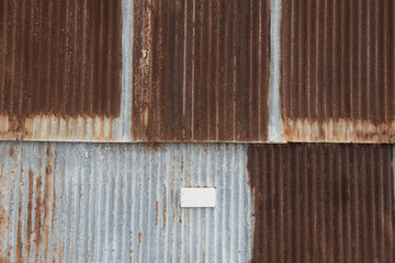 Rusty tin roof background and texture.White power socket on the bottom of picture
