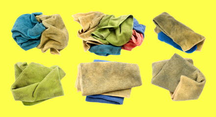 Old dirty torn rag isolated on yellow background. Cleaning rag.