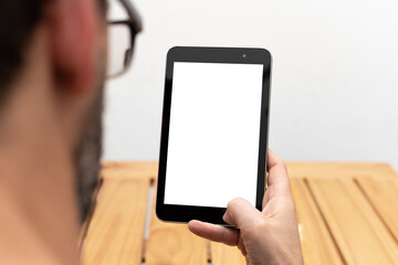 Person looking at a tablet in an upright position with space available