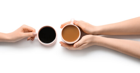 Female hands and cups of coffee on white background