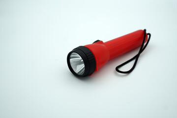 A small red flashlight on a white isolated background  