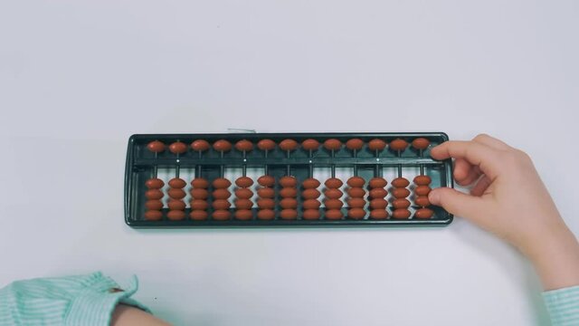 Boy performs arithmetic tasks in Japanese close-up accounts. 4k footage. High quality 4k footage