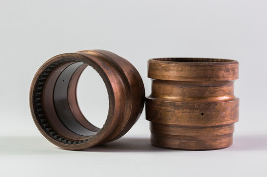 Selective closeup of metallic adapters on a white surface