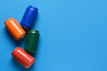 Cans of soda on color background