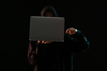 Hacker with laptop on dark background