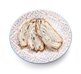 Plate with slices of tasty poppy seed bun on white background