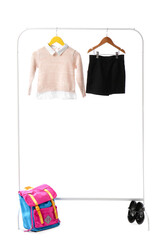 Rack with stylish school uniform on white background