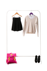 Rack with stylish school uniform on white background