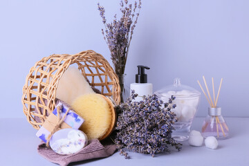Composition with bath supplies and lavender flowers on color background